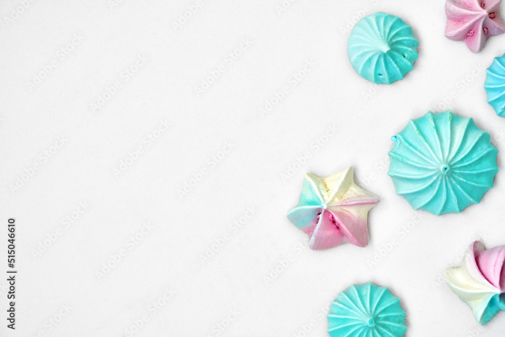 Blue and pink candies in the form of shells on a white burlap background