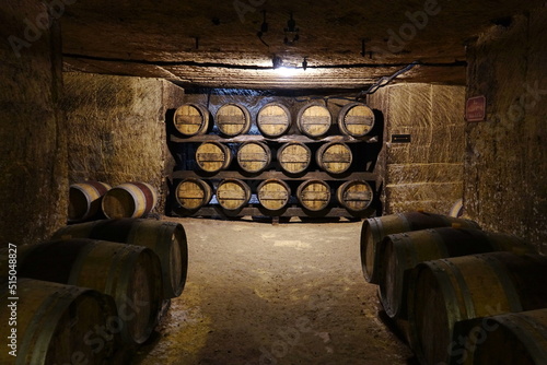 Fototapete Saint Emilion / France - August 2018 : Traditional wine cellar in Saint Emilion with barrels