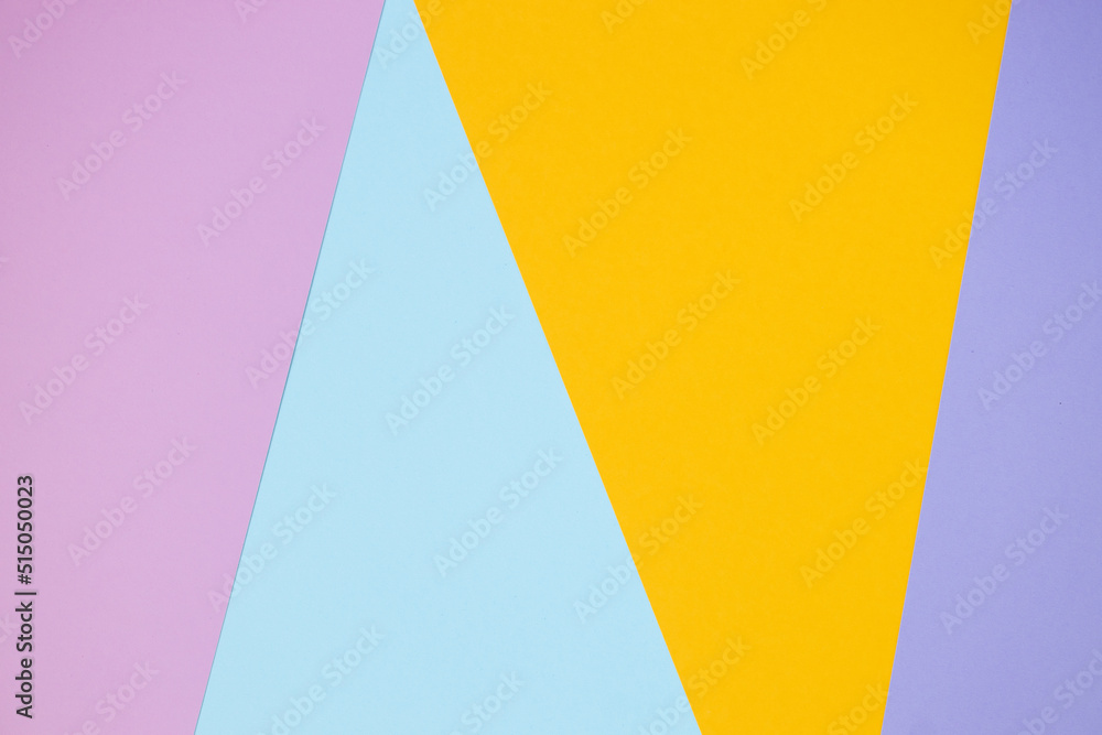 multicolor paper background in yellow, violet. pink and blue