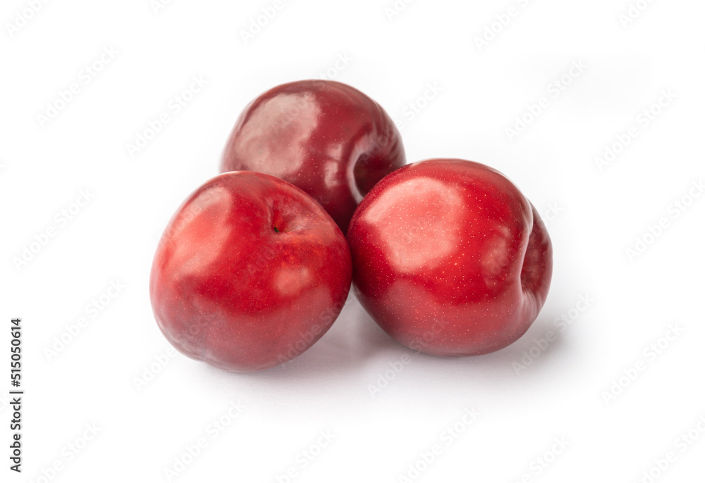A group of red plums isolated over white background