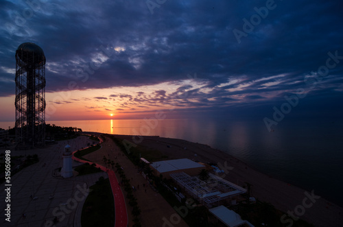 Sunset at the sea with clouds. View of the embankment of Batumi  Adjara