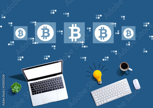 Bitcoin theme with computers with a light bulb from above