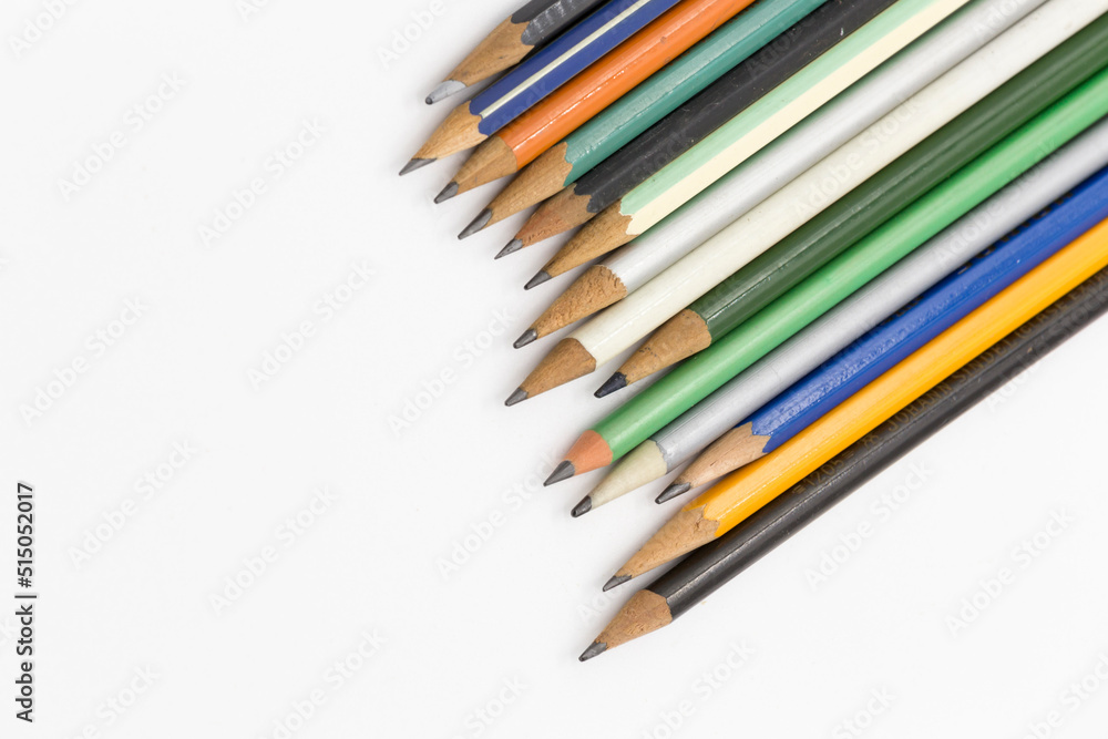 pens of different colors view of their tips in an irregular path, all on a white background