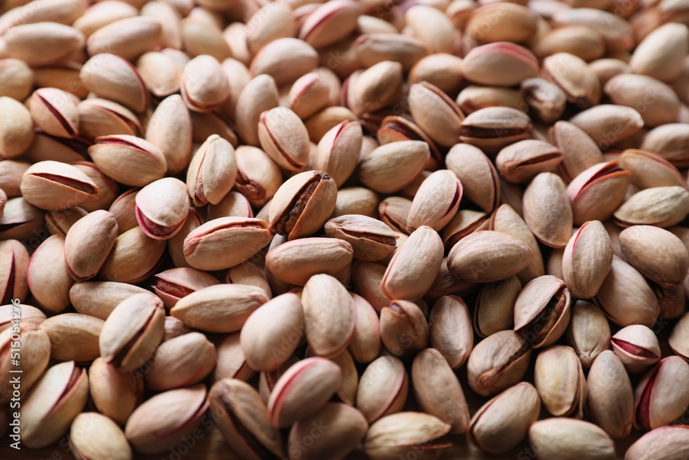 Many tasty pistachios as background, closeup view Many tasty pistachios as background, closeup view