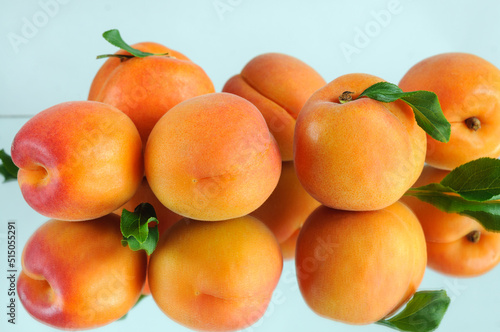 Ripe apricots close-up on a table with a reflective surface. Selective focus, natural lighting