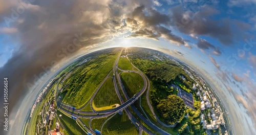 circular rotation with twisting of the landscape of the city and road junction from the height of the flight into a tiny planet 