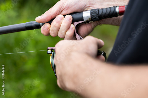Man's hand holding a fishing rod, fishing