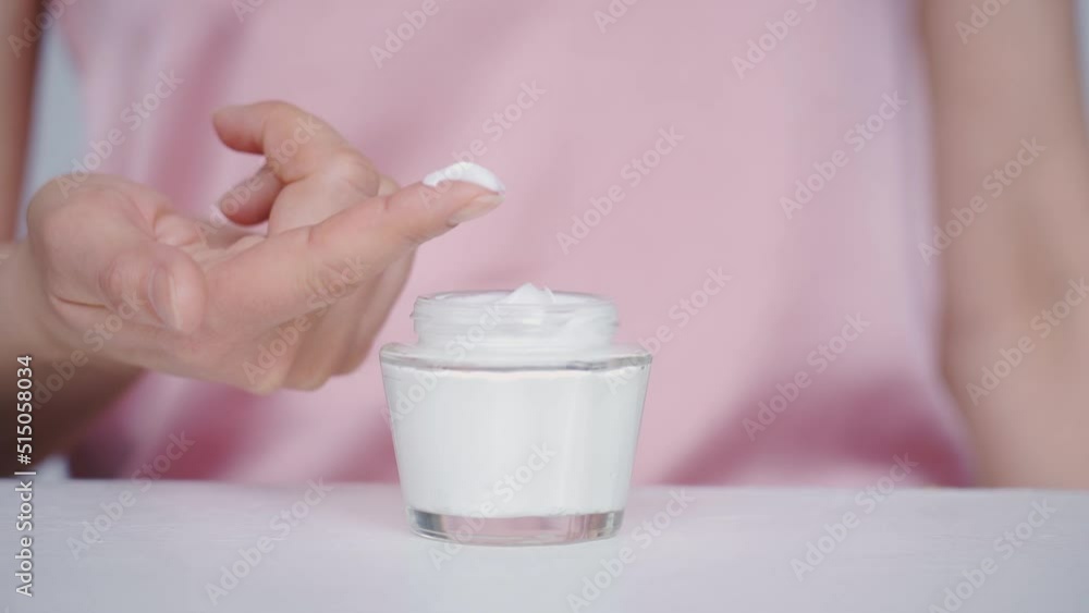 Mid age woman hands, taking face cream for old skin with fingertip. Advertising of antiwrinkle antiaging whitening rejuvenation uv protection women in menopause treatment. Mid age woman hands, taking face cream for old skin with fingertip. Advertising of antiwrinkle antiaging whitening rejuvenation uv protection women in menopause treatment.