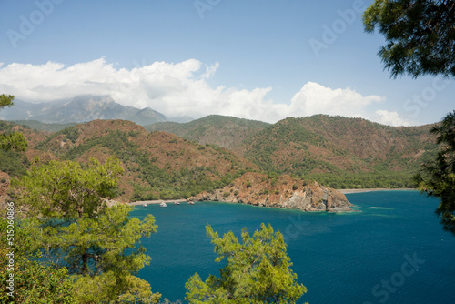 Picturesque landscape. View of Mediterranean Sea from top of hill. Postcard view of sea bay surrounded by mountains and hills. Hike along Lycian Way, Antalya, Kemer, Turkey. Spring
