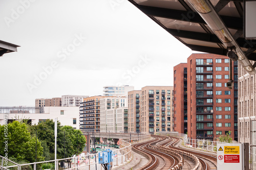 DLR Docklands Light Railway train at West Silvertown Station in London. DLR train arriving the station on a bright day, London,  England, June 19, 2022
 photo