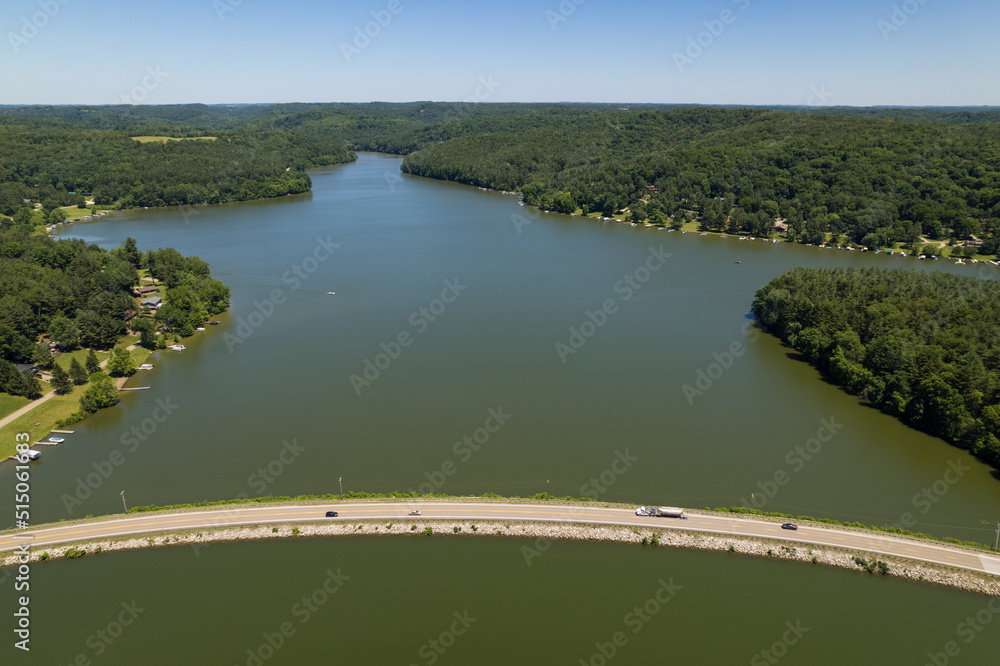 Fototapeta premium Curving Road Bypasses Lake and Forest