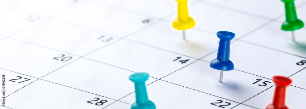 Colorful Push Pins On Calendar Showing Busy Schedule - Business Planning Concept Colorful Push Pins On Calendar Showing Busy Schedule - Business Planning Concept