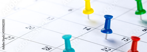 Colorful Push Pins On Calendar Showing Busy Schedule - Business Planning Concept