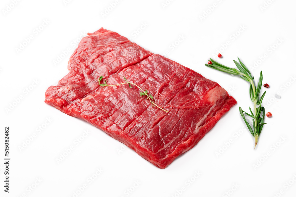 Raw flank steak or Outside skirt steak isolated on white color by seasonings and herbs - obrazy, fototapety, plakaty 