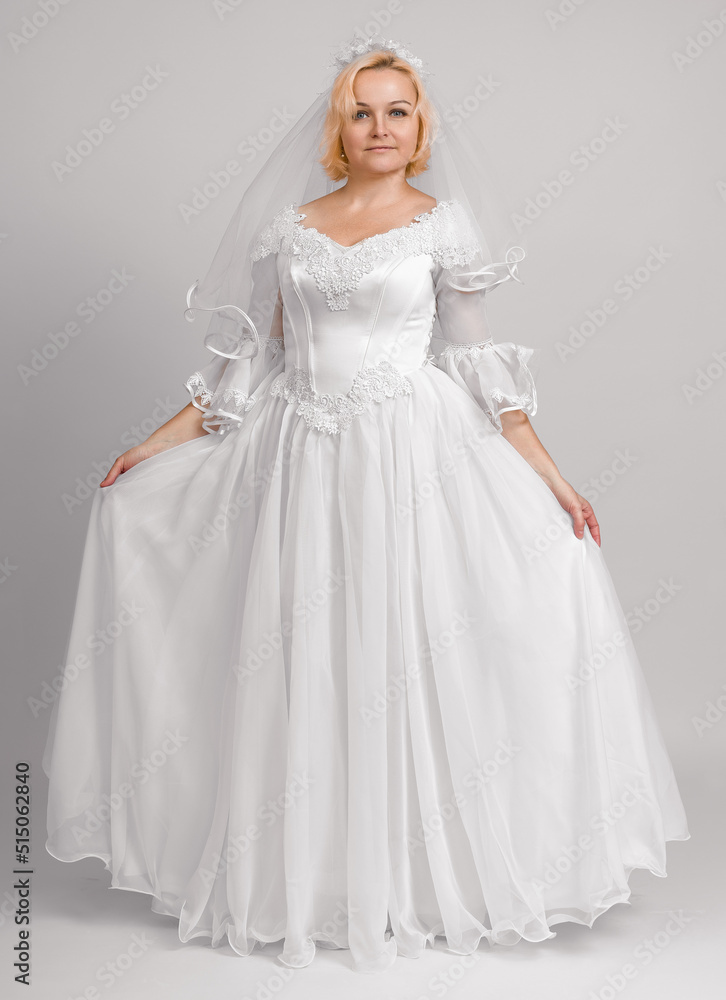 Fototapeta premium bride in long white dress, studio shot, full length