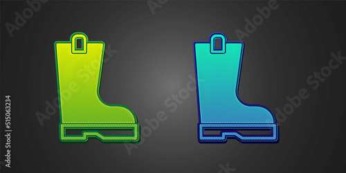 Green and blue Waterproof rubber boot icon isolated on black background. Gumboots for rainy weather, fishing, gardening. Vector