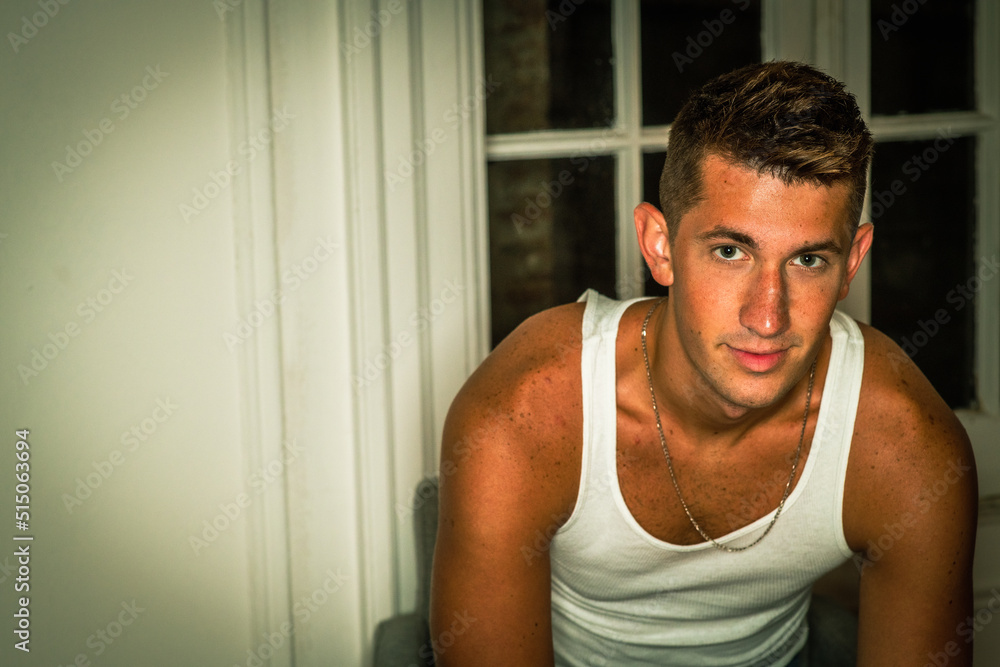 Young Handsome American Man relaxing inside at home in hot summer. Young Handsome American Man relaxing inside at home in hot summer.