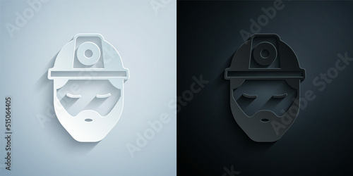 Paper cut Builder icon isolated on grey and black background. Construction worker. Paper art style. Vector