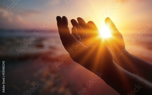 Silhouette person on sunset background. Raising his hands in worship. Christian Religion concept background.