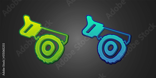 Green and blue Hand saw and log icon isolated on black background. Vector