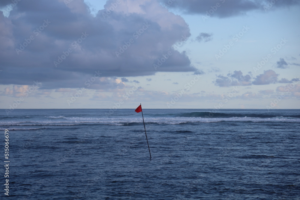 red flag on beach, red warning flag on sea