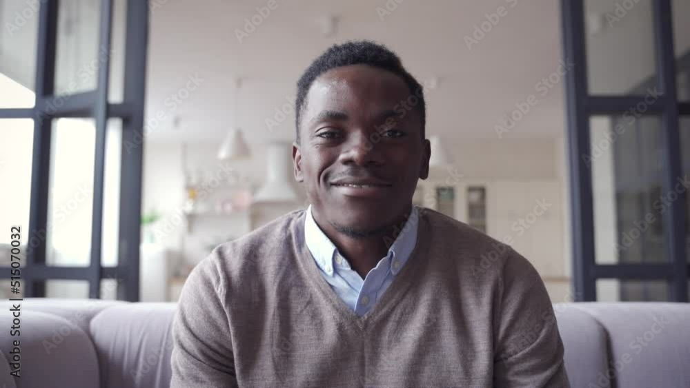 Happy African young man online teacher, coach, distance worker waving hand talking to camera or web cam video conference calling in virtual webcam chat meeting by remote video call. Happy African young man online teacher, coach, distance worker waving hand talking to camera or web cam video conference calling in virtual webcam chat meeting by remote video call.