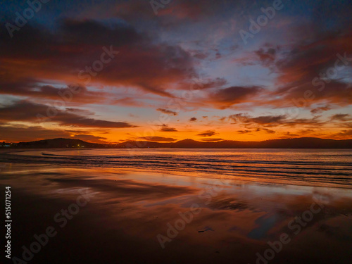 Winter sunrise at the seaside with high cloud and reflections
