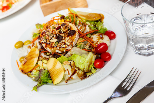 Appetizing salad with goat cheese served on plate. Spanish cuisine