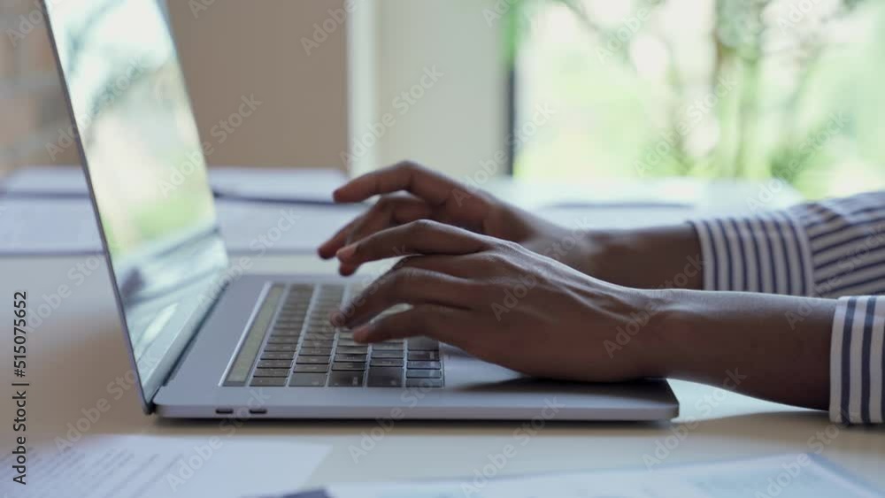Young black female hands typing on pc keyboard. African business woman user using laptop computer working online, searching tech data in internet sitting at desk in home office. Close up view.