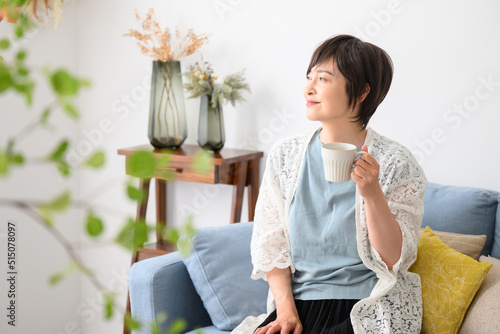 Woman relaxing with a cup of coffee, etc.