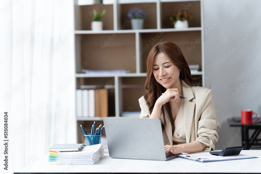Asian woman working with laptop in her office. business financial concept. Asian woman working with laptop in her office. business financial concept.