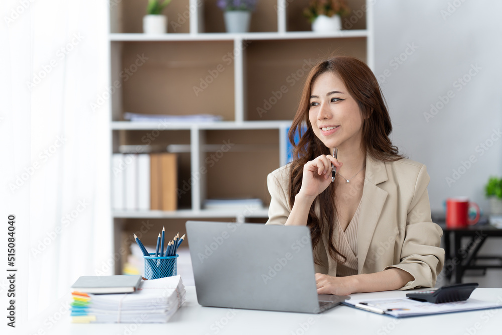 Asian woman working with laptop in her office. business financial concept. Asian woman working with laptop in her office. business financial concept.