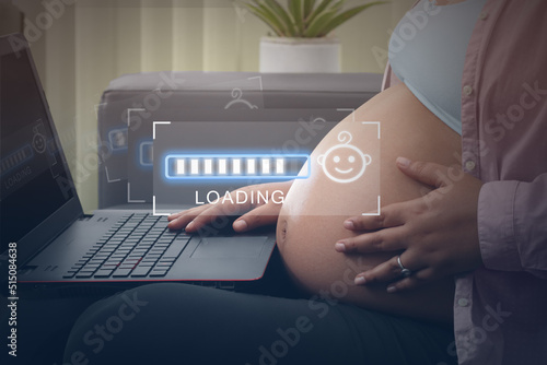 Concept maternity, pregnant woman watching on laptop loading bars 8 months