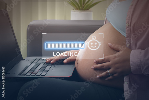 Concept maternity, pregnant woman watching on laptop loading bars 9 months