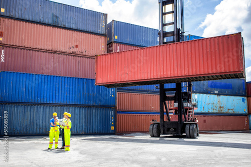 Manager standing and meeting with his staff in container depo company area. worker working checking at Container cargo harbor to loading containers.