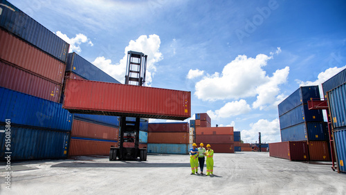 Manager standing and meeting with his staff in container depo company area. worker working checking at Container cargo harbor to loading containers.