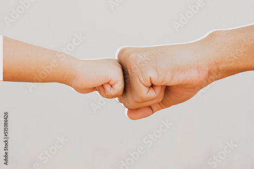 Father's big fist and son's little hand collide with each other, strength training and early childhood learning teaching : Clipping path