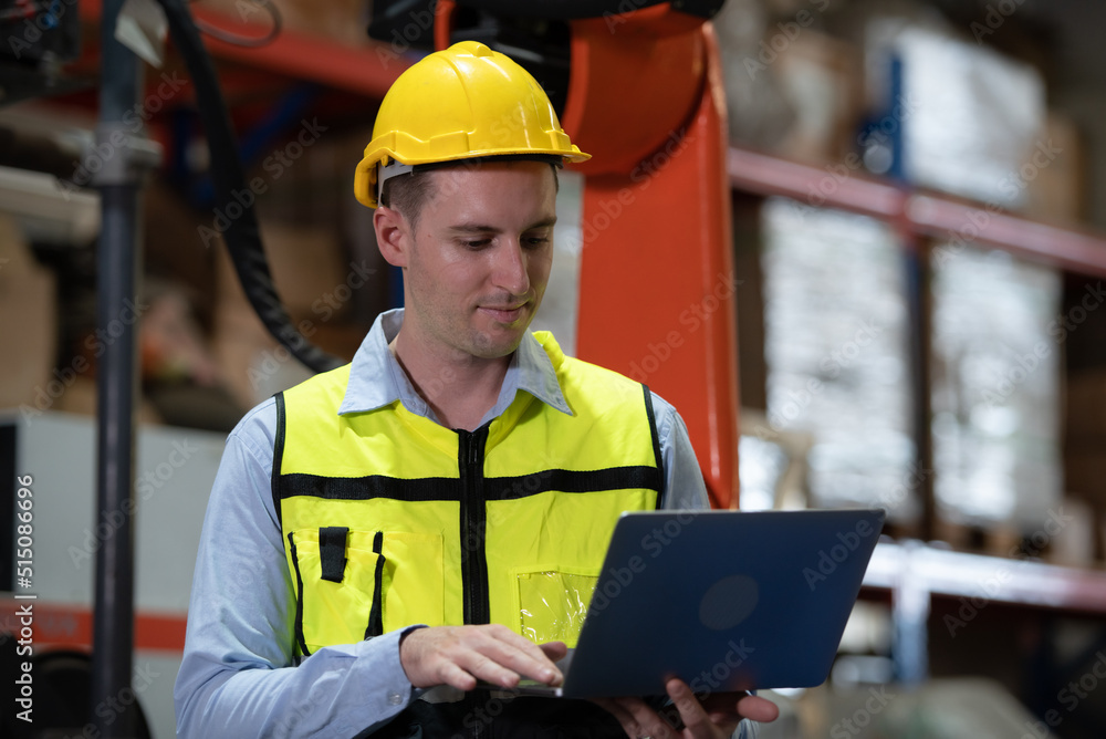 A male engineer checking the operation of a welding robot. used for precision welding control Fast and highly secure A male engineer checking the operation of a welding robot. used for precision welding control Fast and highly secure