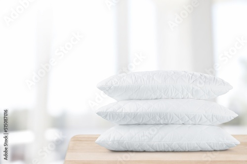 Fototapeta Naklejka Na Ścianę i Meble -  Hypoallergenic pillows in natural pillowcases lying. Laundry day, cotton bedding and cleaning service concept