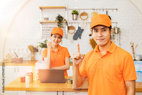 Handsome male employee shows the number one andfemale employee are on the lookout for online pre-order food delivery services. Find food delivery products that are convenient fast safe.