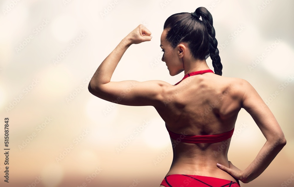 Obraz premium Beautiful fitness woman. Athletic girl posing on background, abs and flat belly