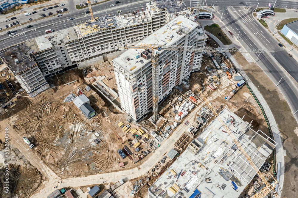 aerial view of construction site of residential area buildings with cranes. birds eyes view.