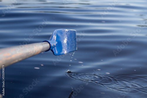 The blue paddle from the boat was rowing the water