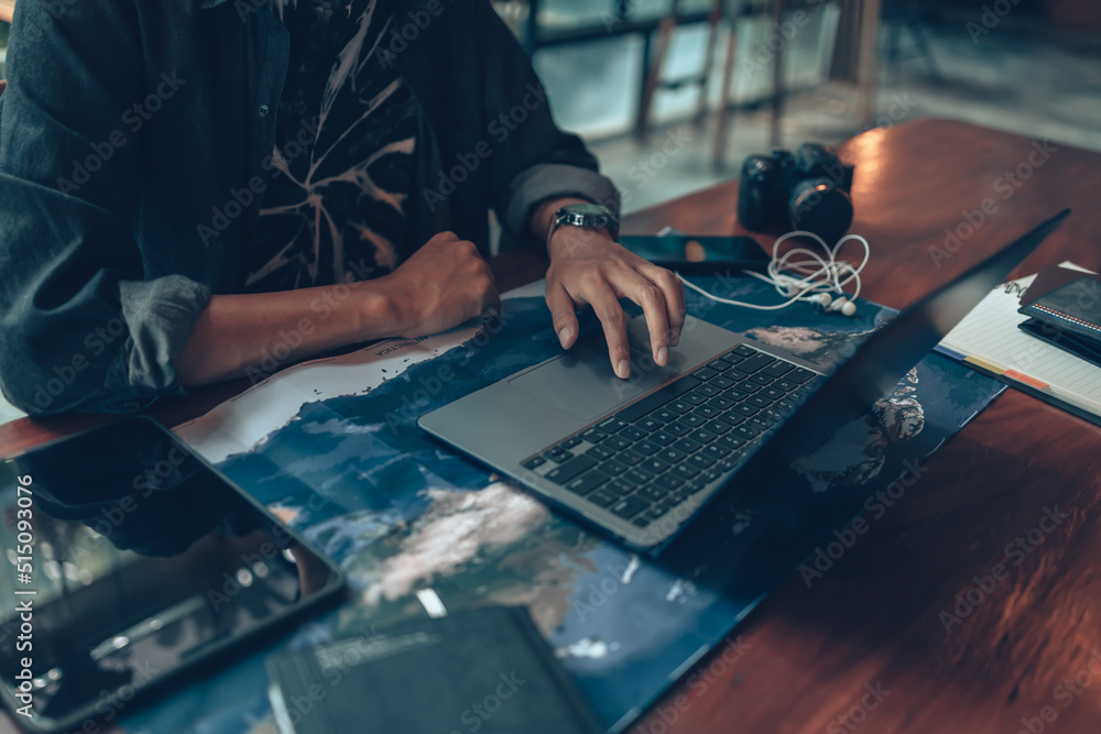 Travelers planning trips and use laptop to book hotels, buy plane tickets, search map, or find travel routes. Travel concept. Travelers planning trips and use laptop to book hotels, buy plane tickets, search map, or find travel routes. Travel concept.