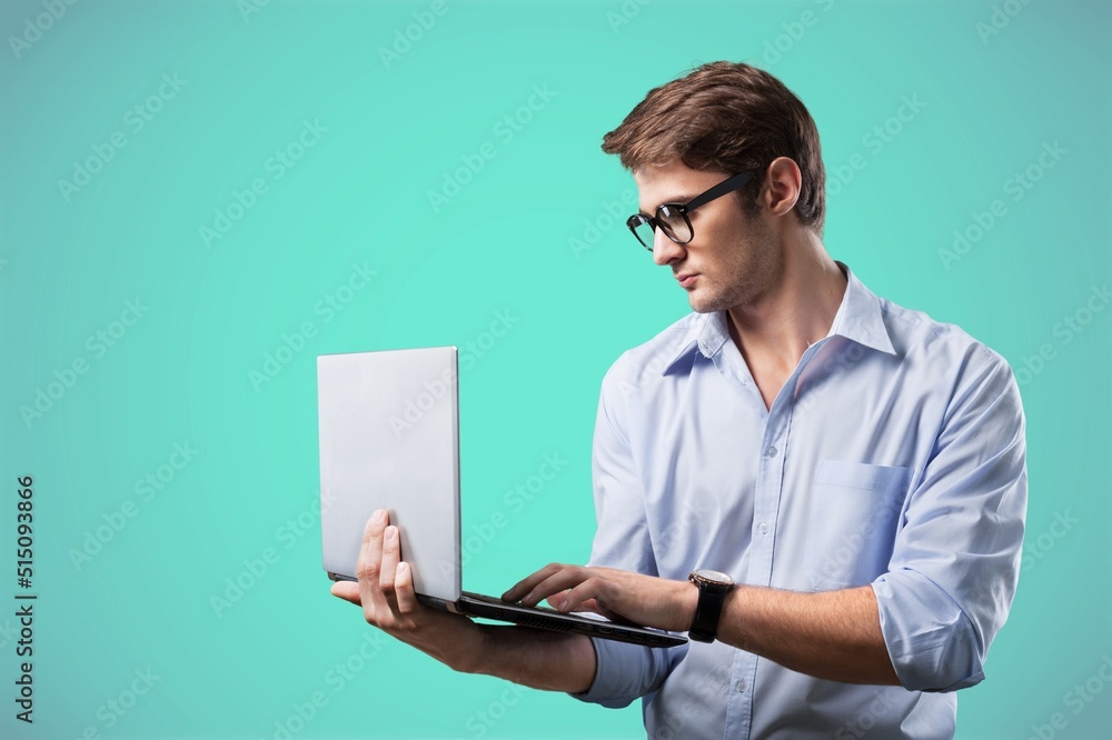 Optimistic male student or worker using laptop pc Optimistic male student or worker using laptop pc