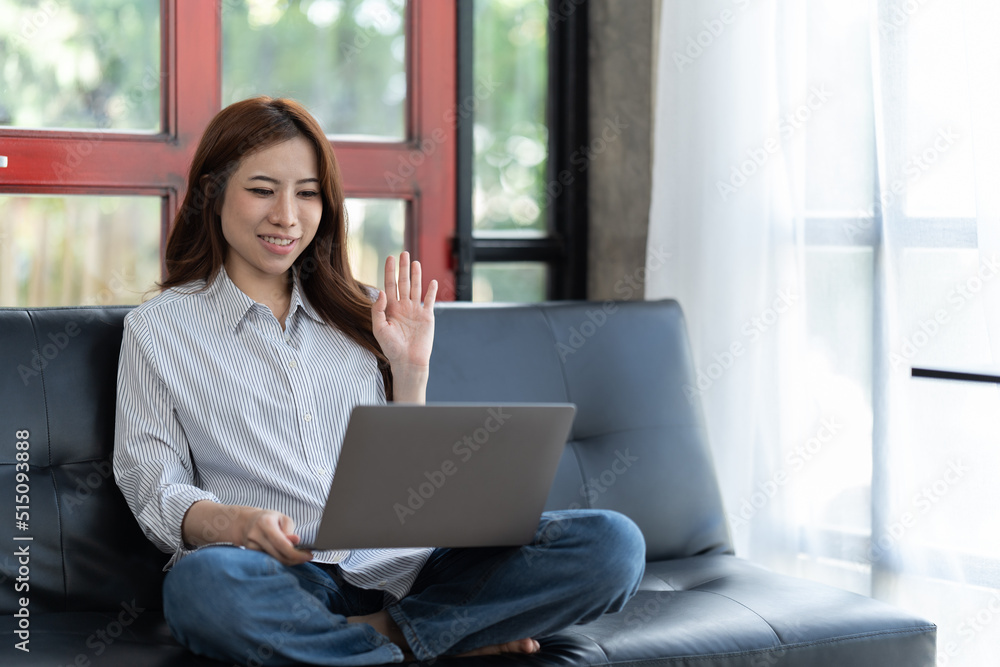 Happy young woman using laptop at home sitting on soft couch. Lady is working on laptop computer. Girl student is typing message using laptop keyboard. Happy young woman using laptop at home sitting on soft couch. Lady is working on laptop computer. Girl student is typing message using laptop keyboard.