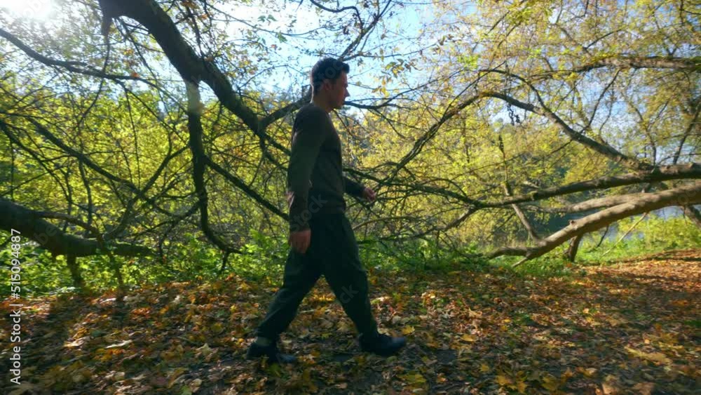 A Young Active Man Jumping Over The Big Tree Trunk During Fall Season In Lithuania, Europe- Tracking Shot A Young Active Man Jumping Over The Big Tree Trunk During Fall Season In Lithuania, Europe- Tracking Shot