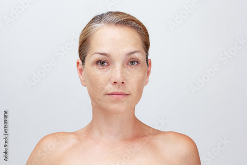 Portrait of caucasian middle aged beautiful woman of 40s with grey hair on white background looking at camera