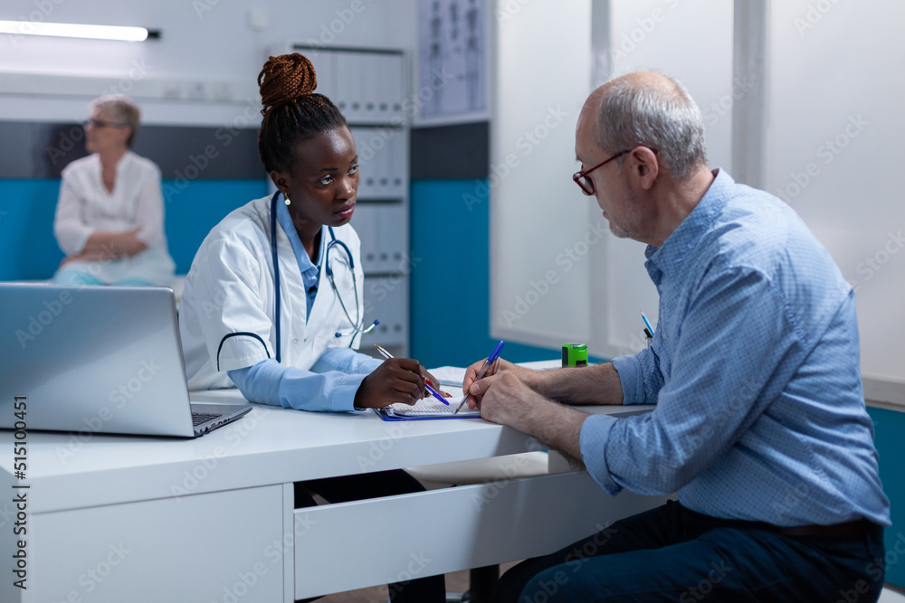 Clinic specialist conversating with retired patient about disease symptoms and examination appointment while checking medicine side effects. Healthcare specialist expert recommend man recovery Clinic specialist conversating with retired patient about disease symptoms and examination appointment while checking medicine side effects. Healthcare specialist expert recommend man recovery