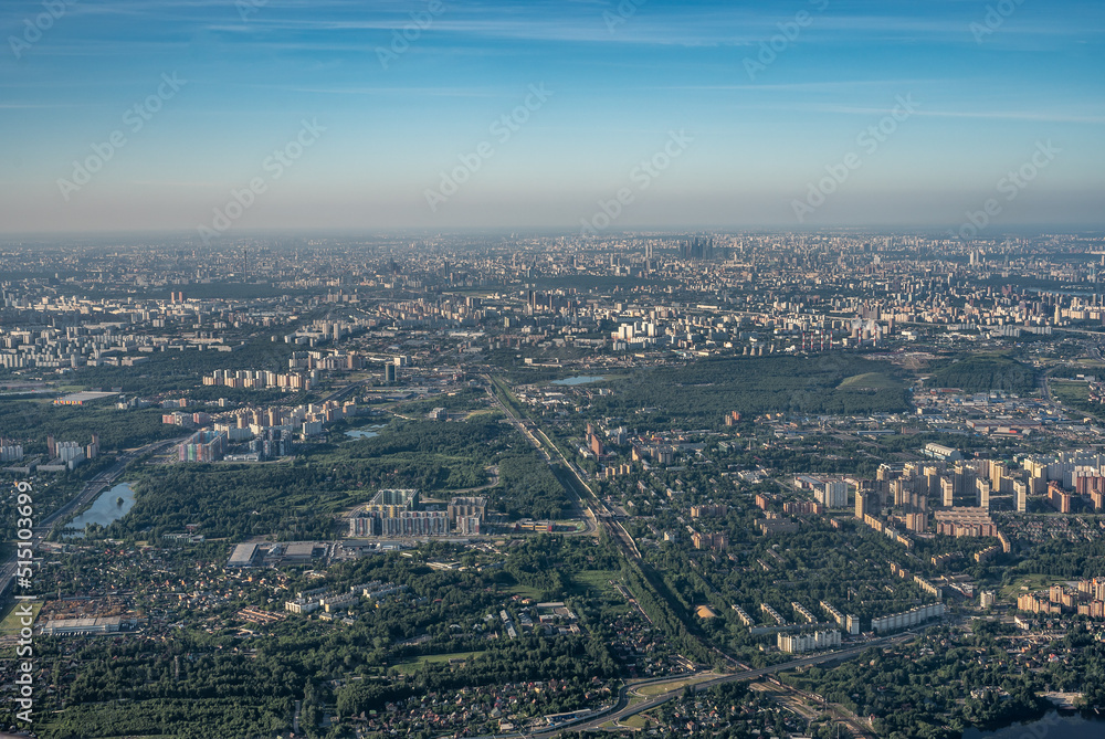 Aerial view photo from airplane of city and clear sky. aerial photo of large city from an airplane window. view of city of Moscow through window from plane